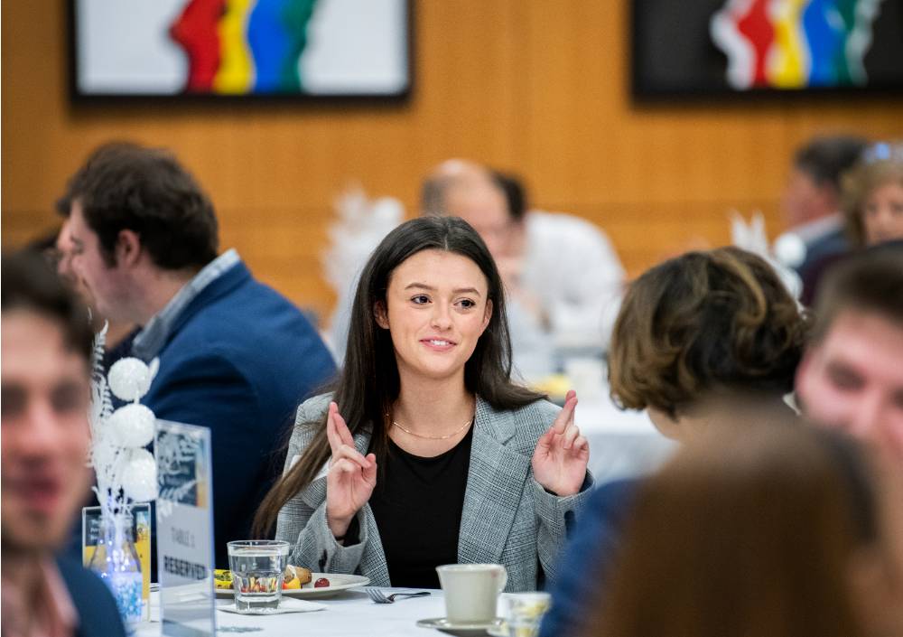 Student crossing her fingers before going on stage at the Secchia Breakfast Lecture on Jan 27, 2023